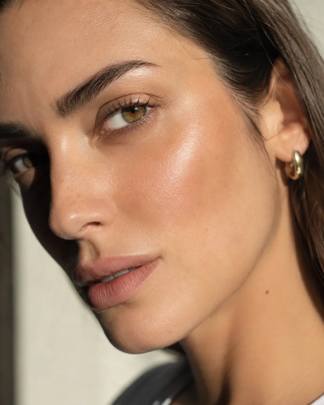 Confident close-up portrait with refined skin and warm editorial light